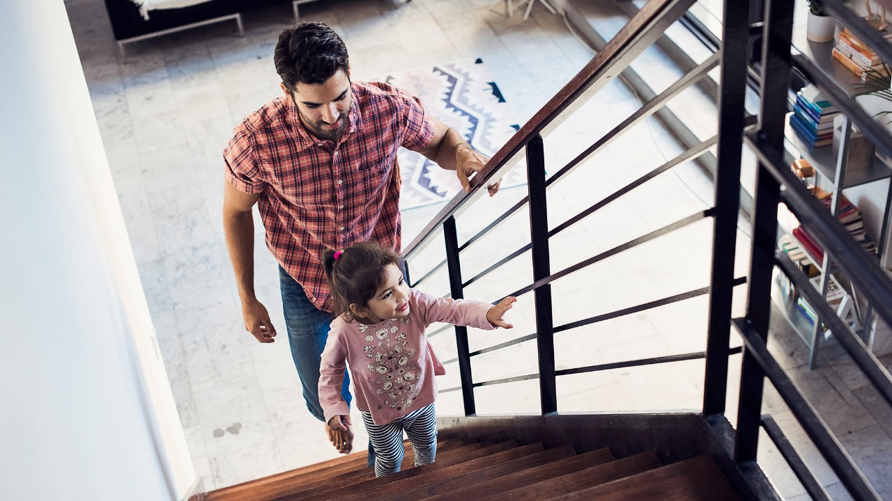 dad and daughter climbing up the stairs