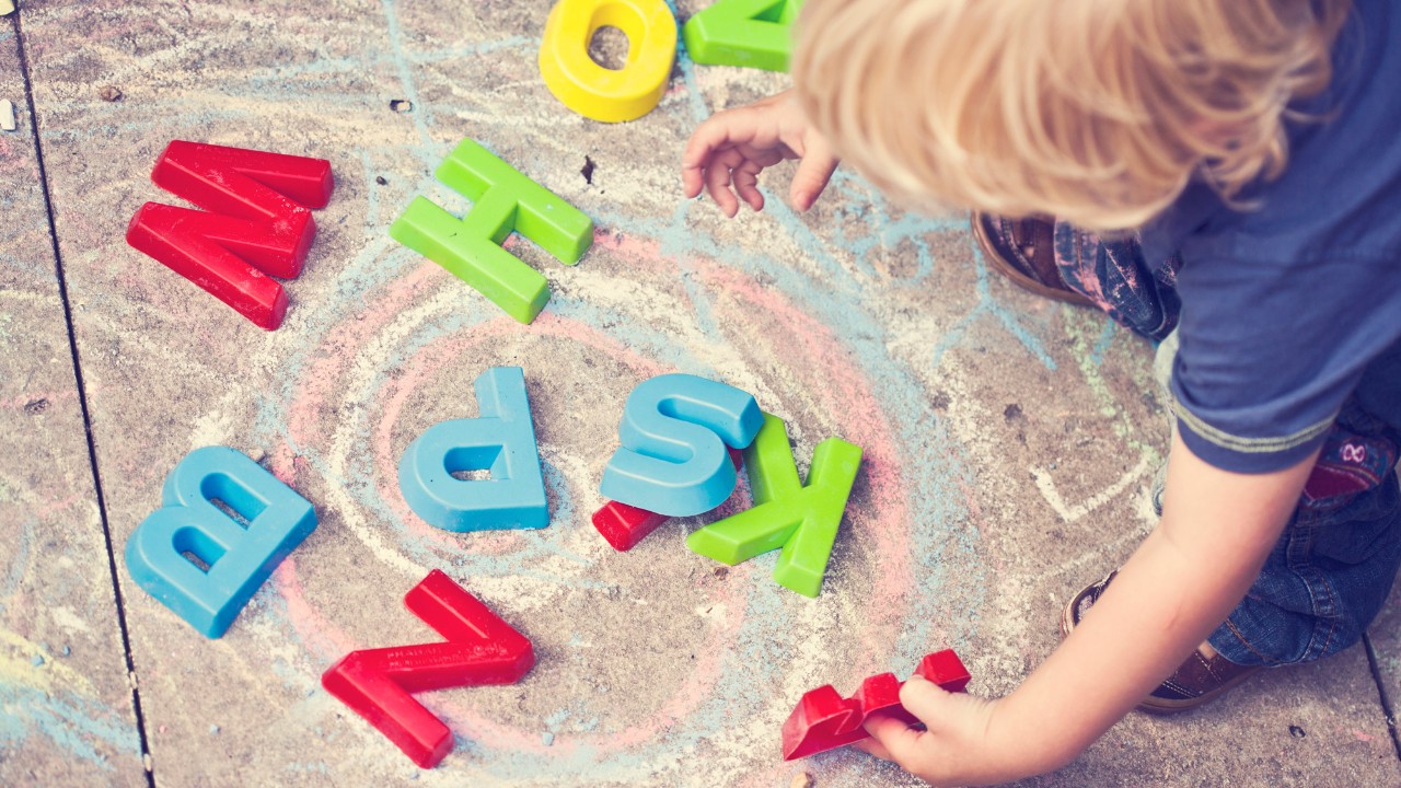 Child playing with alphabet blocks