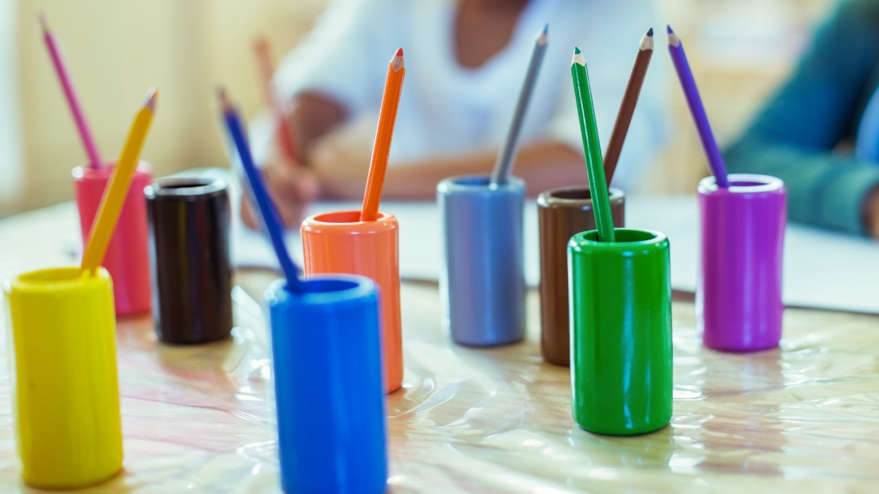 Colored pencils on desk in classroom