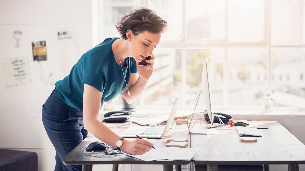 a women calling and writing