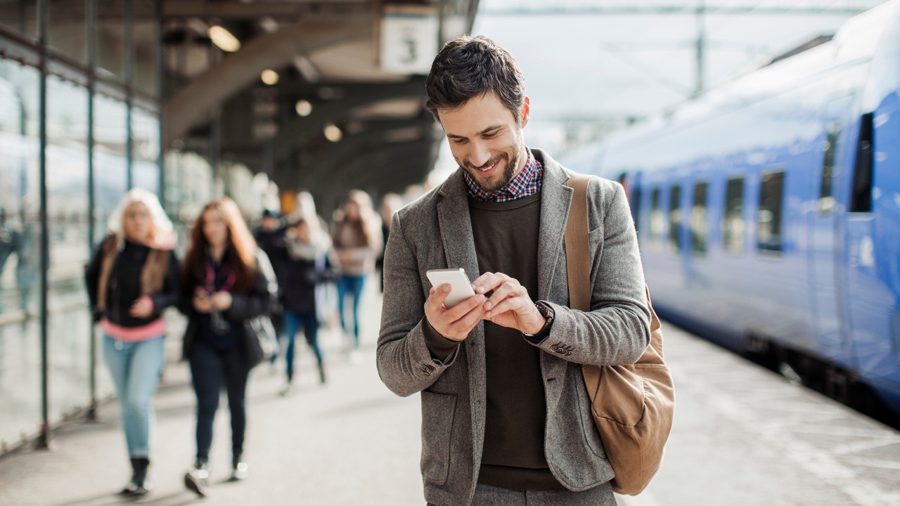 Man using mobile at the train station