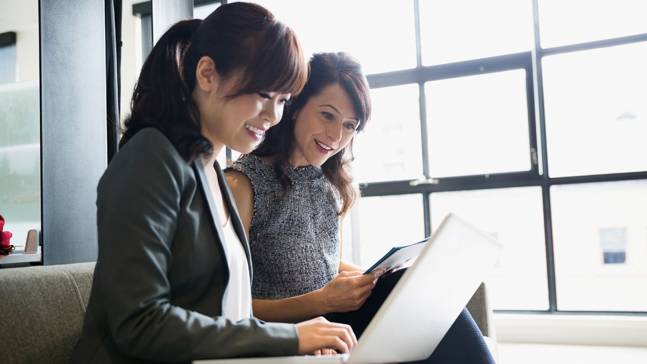 Two women looking at the laptop screen