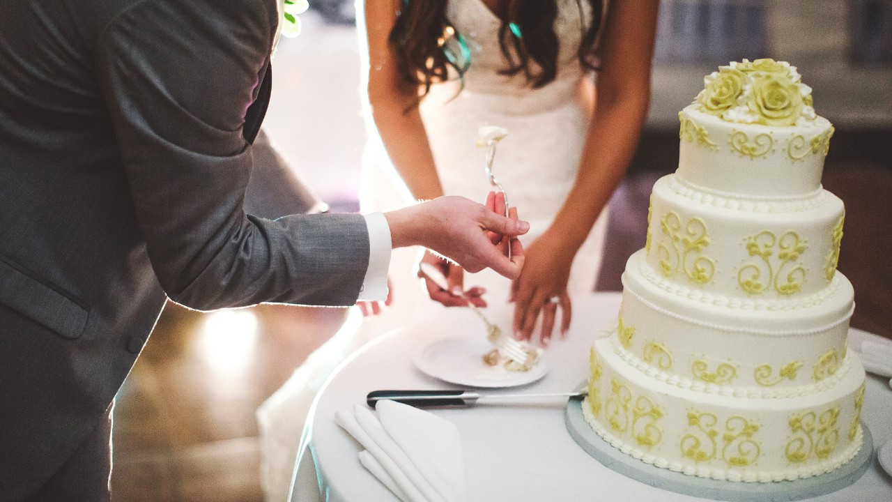 Couple eating wedding cake
