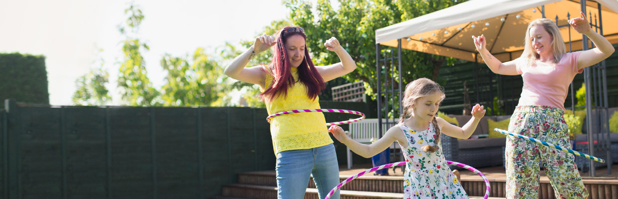 Couple and daughter playing with plastic hoops