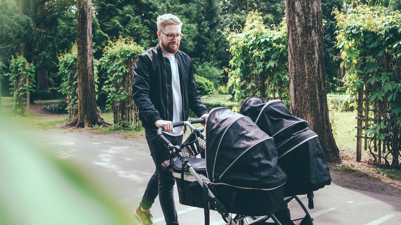 man pushing a stroller outside