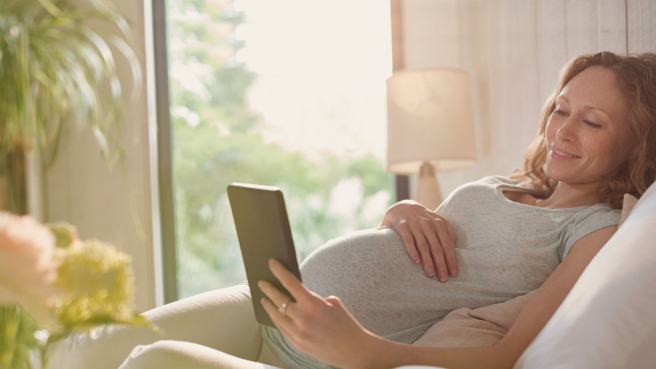 pregnant woman with tablet