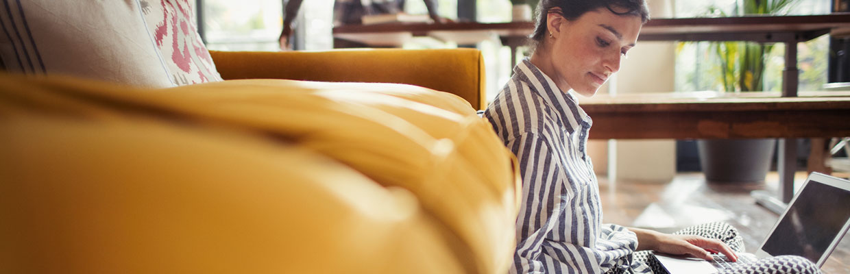 woman with laptop yellow couch